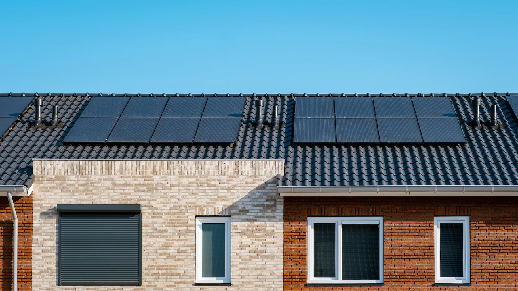 Solar panels fitted across the roof of a modern brick home